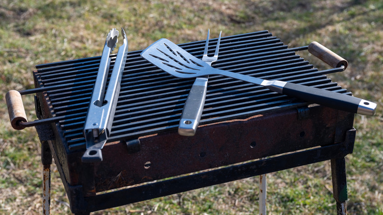 Set of grilling tools on an outdoor grill