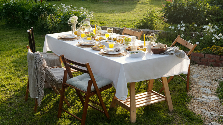 Outdoor dining table set for an evening dinner with a cozy vibe