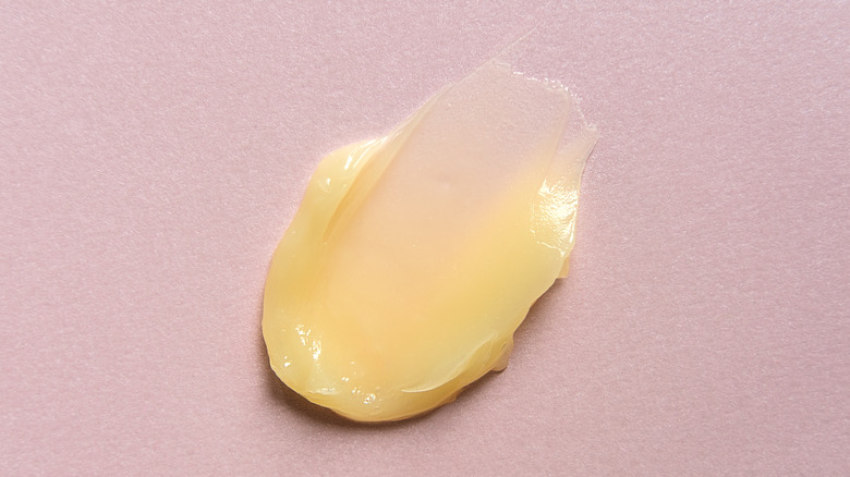Smear of soft butter on a pink background