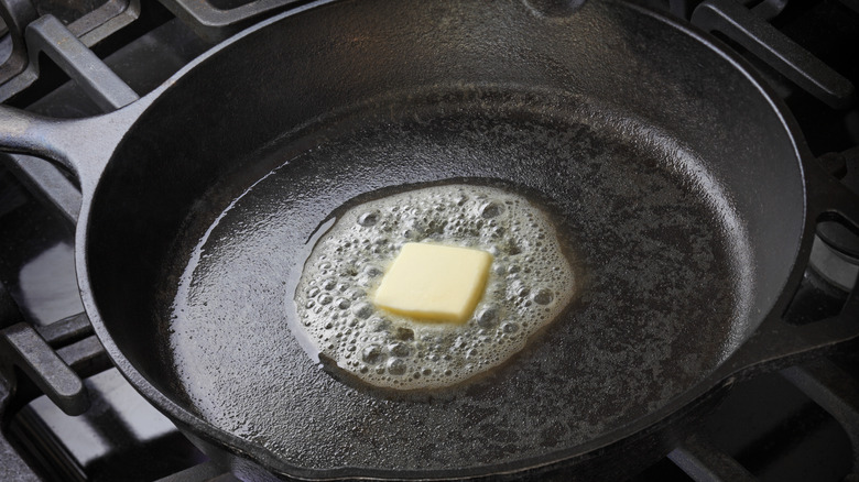 Skillet on stove, with butter melting in it