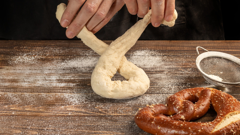 Person shaping pretzel dough