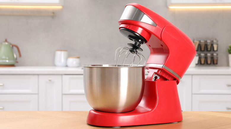 Red stand mixer on wooden kitchen counter