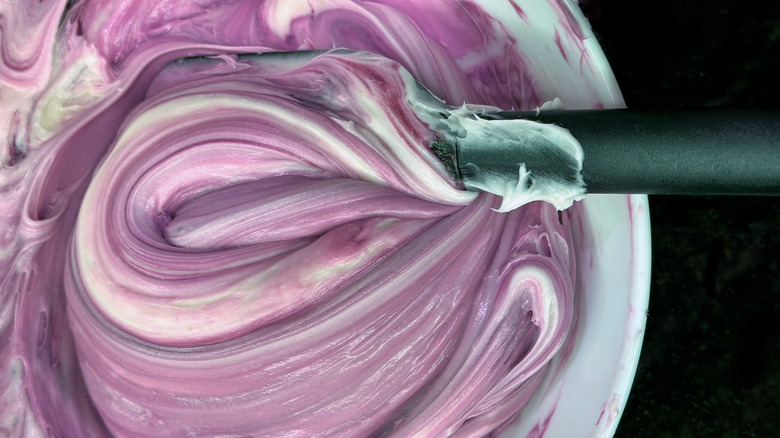 Close up on purple and white streaked icing