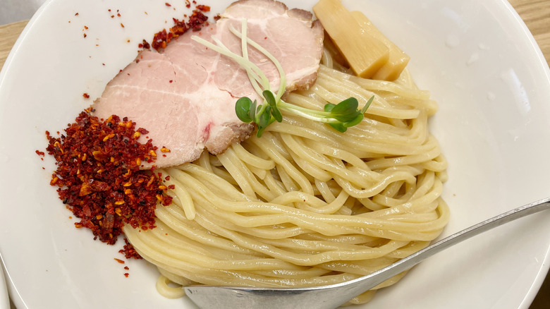 Bowl of Tsukemen, with cooked pork, chili flakes, and ginger slices