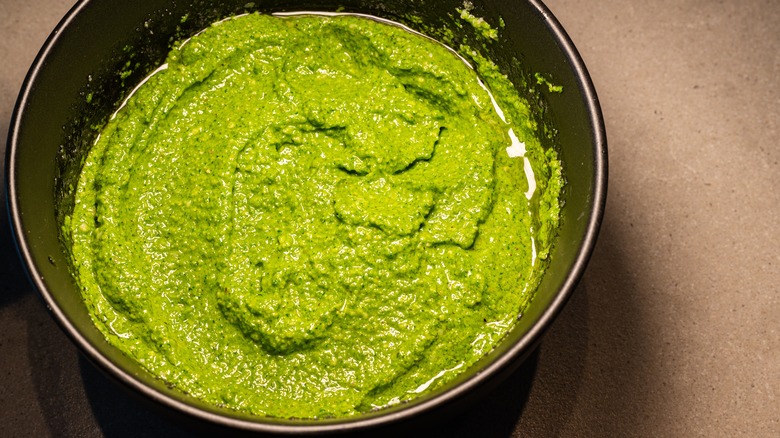 homemade pesto in black bowl