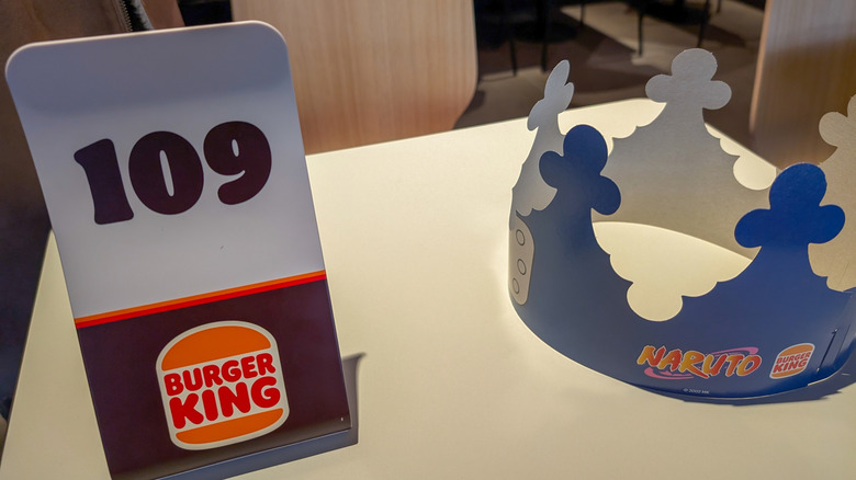 Burger King table, with numbered order sign and a paper crown