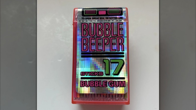 Square, pink, plastic container of Bubble Beeper gum