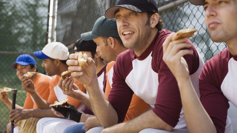 Baseball team eating pizza