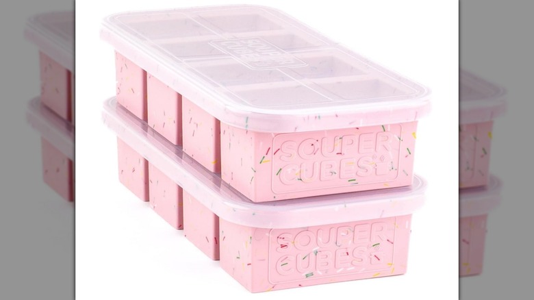 A two-pack of pink Souper Cubes freezer molds with lids on a white background