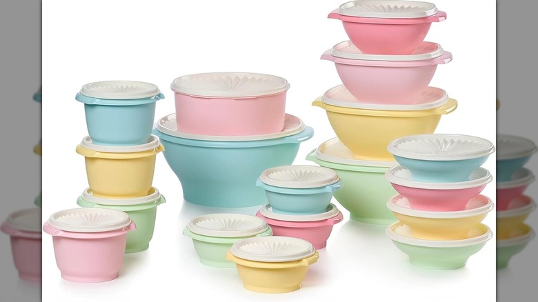 A set of 18 Tupperware Heritage containers with lids in pastel colors on a white background