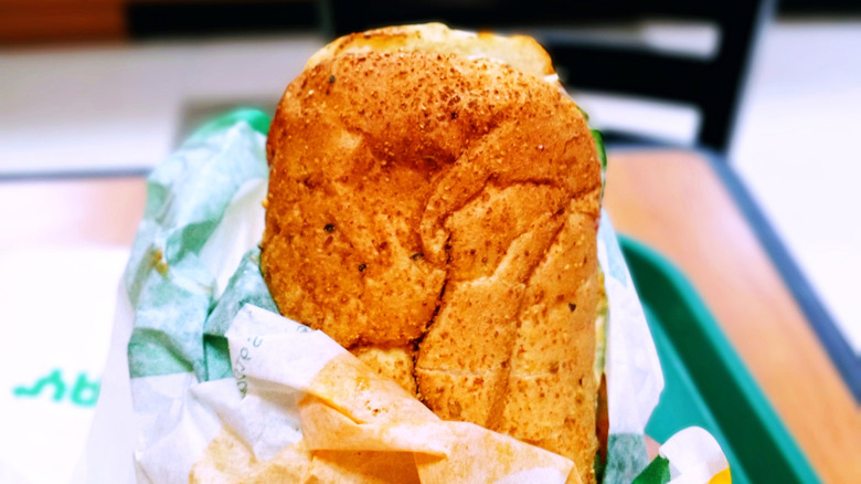 The edge of an unwrapped Subway sandwich