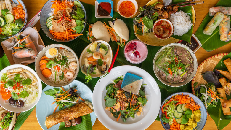 table with multiple Vietnamese dishes