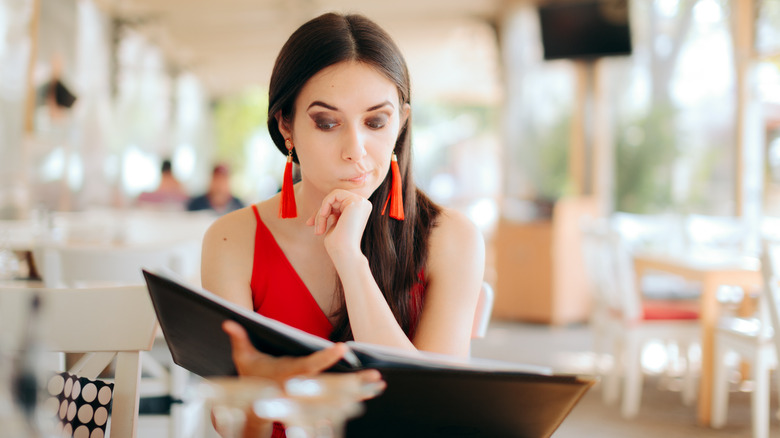 woman looking at menu