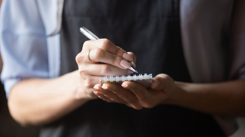 closeup waiter taking order