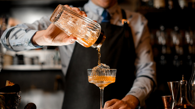 Bartender pouring a cocktail