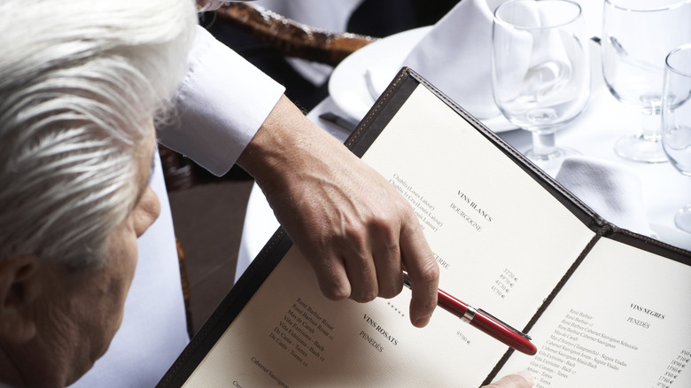 Waiter pointing at menu