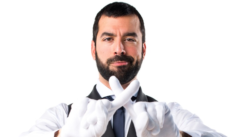 Waiter making x sign