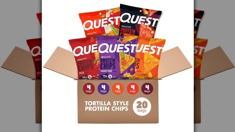 Quest variety pack with red, orange, purple, and black bags in a cardboard box on white background
