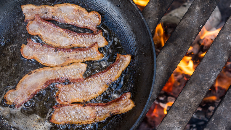 bacon cooking over fire