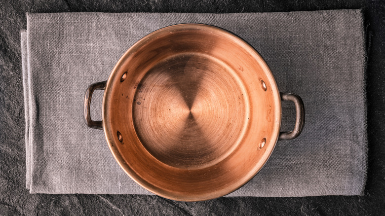 copper pot on grey cloth