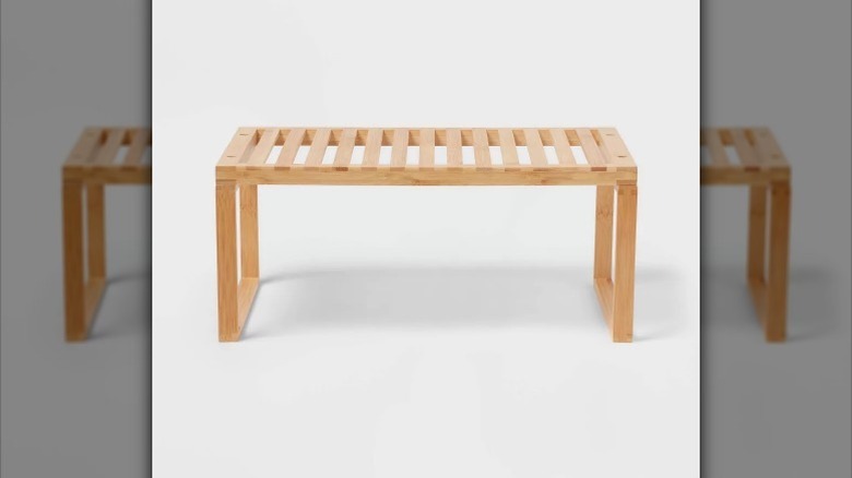 Light colored slatted bamboo shelf on white background