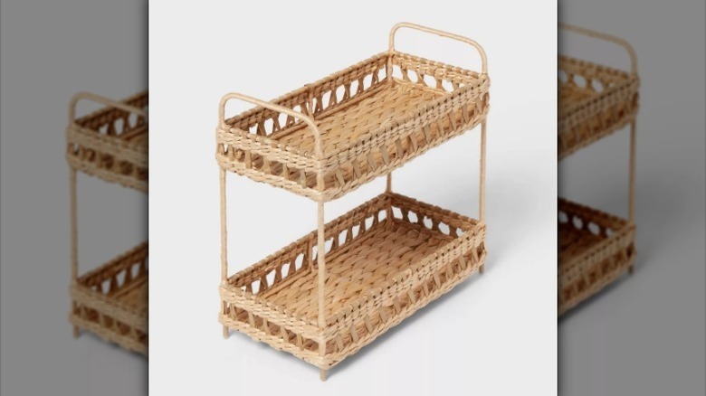 Woven two tiered basket shelf on white background