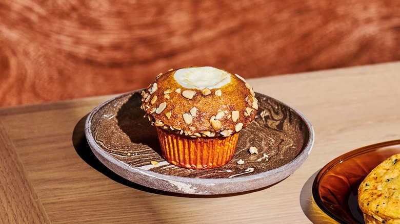 Starbucks' pumpkin cream cheese muffin on an earthy-colored plate