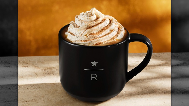 Black mug of Starbucks Reserve pumpkin spice latte on a marbled table