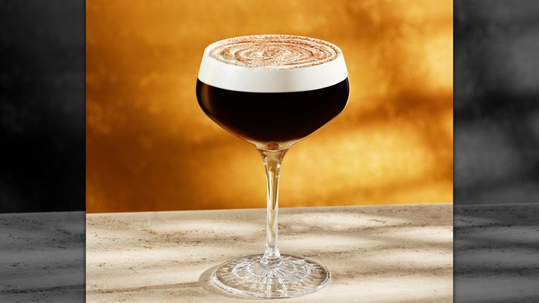 Starbucks Reserve pumpkin spice whiskey barrel-aged Manhattan on a marbled table