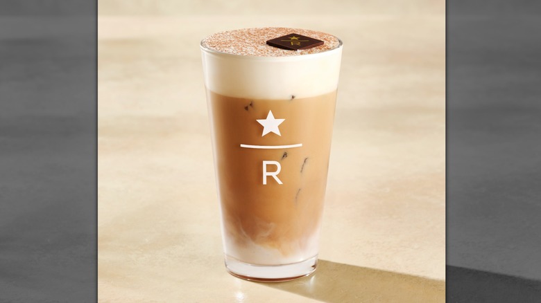 Glass of Starbucks Reserve iced tiramisu latte on a marbled table