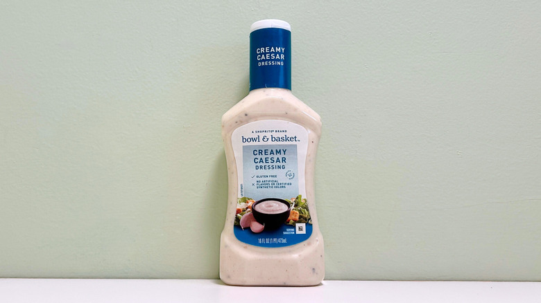 A bottle of Bowl and Basket Creamy Caesar Salad Dressing
