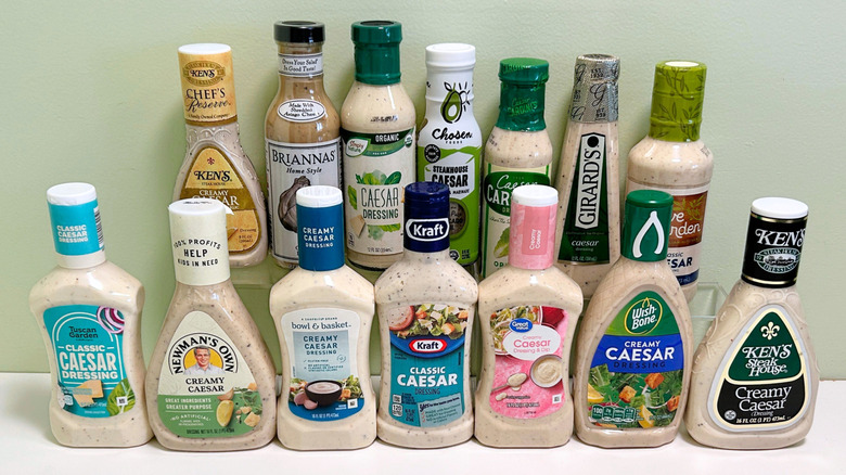 Several bottles of Caesar dressing arranged in two rows