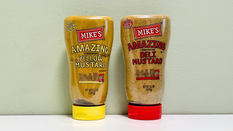 Bottles of Mike's Amazing Stoneground Yellow Mustard and Mike's Amazing Stoneground Deli Mustard