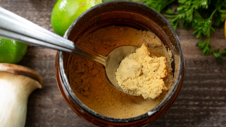 A top-down view shows a spoon scooping out some bouillon powder.