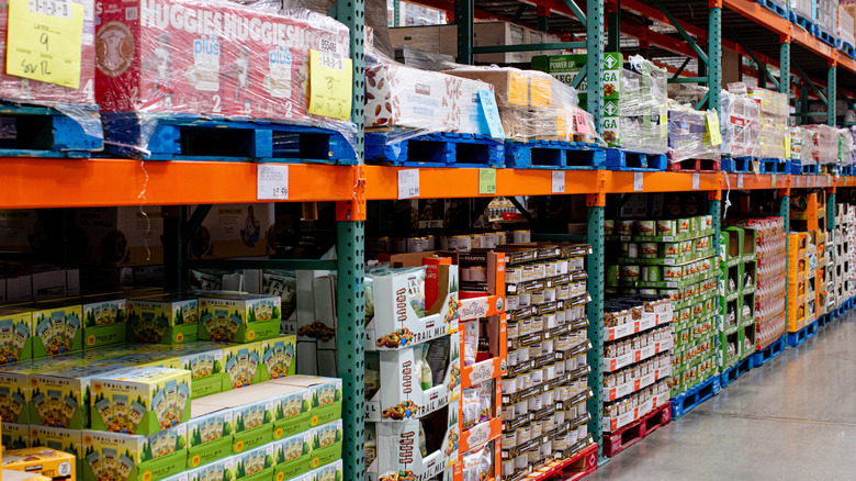 Stocked Costco shelves, displaying various open and unopened items