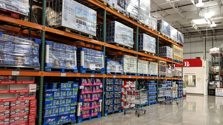 Aisle in Costco with shrink-wrapped product crates on shelves