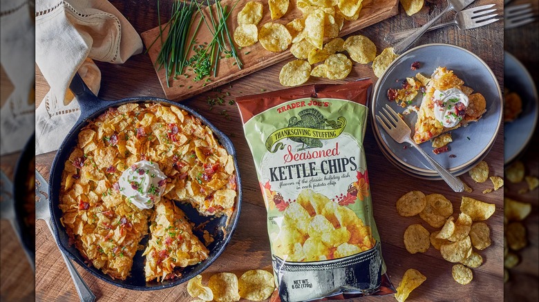 A bag of Trader Joe's Thanksgiving stuffing seasoned kettle chips amid a Thanksgiving spread