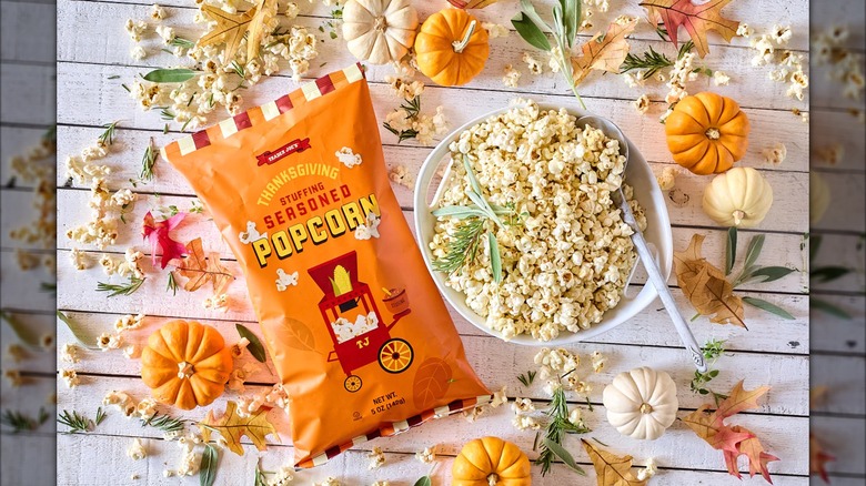 A bag of Trader JOe's Thanksgiving stuffing seasoned popcorn, next to a bowl of the same