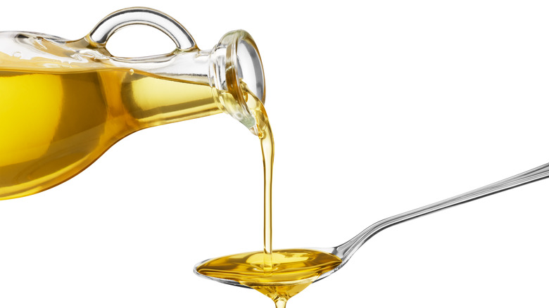 pouring olive oil on spoon