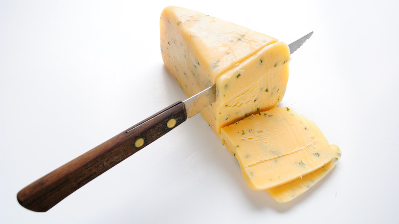 sliced wedge of cotswold cheese