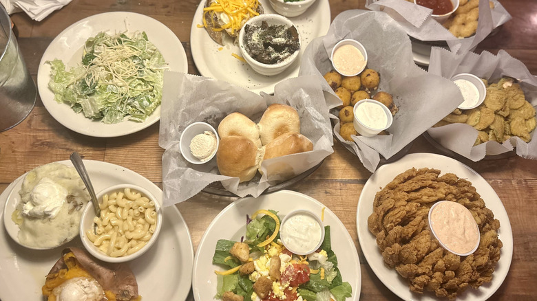 A collection of appetizer and side menu items on a table at Texas Roadhouse