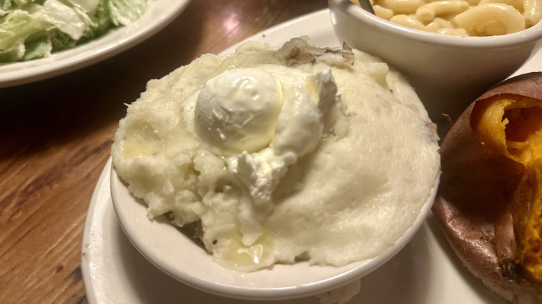 A small bowl of mashed potatoes with butter as a side at texas roadhouse