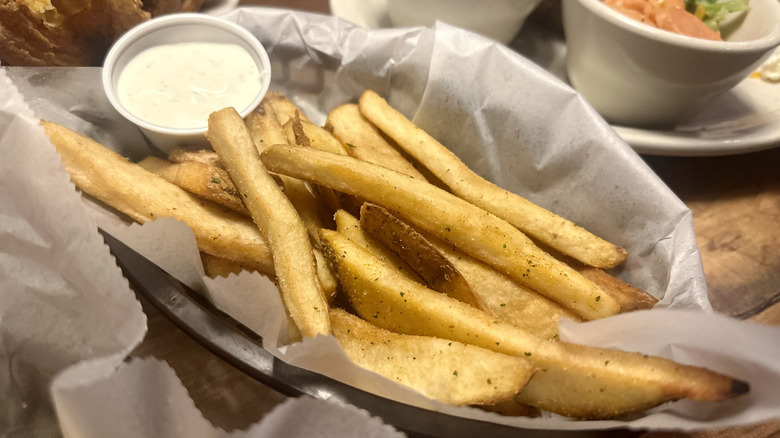 Classic steak fries in long slices in a basket at a chain restaurant