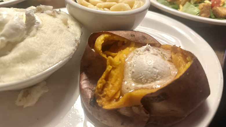 A baked sweet potato with cinnamon honey butter from texas roadhouse