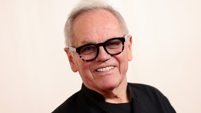 Wolfgang Puck grinning, against a white background