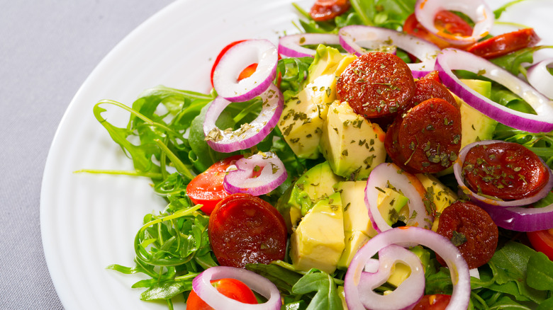 Fresh salad with fried sausage slices