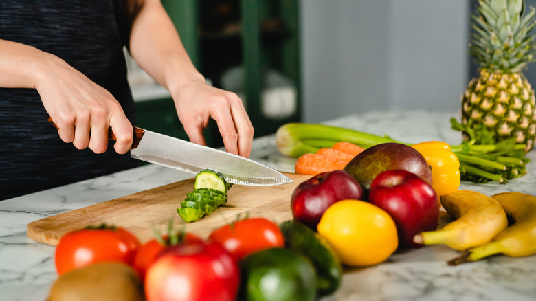 Person cutting fruits and vegetables