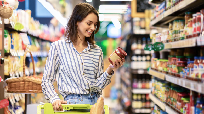 Woman checking price of a jar