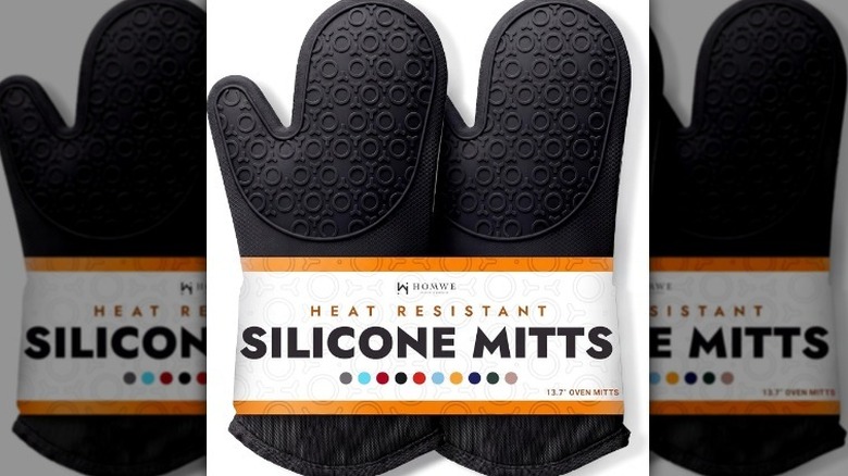 Silicone oven mitts on white background