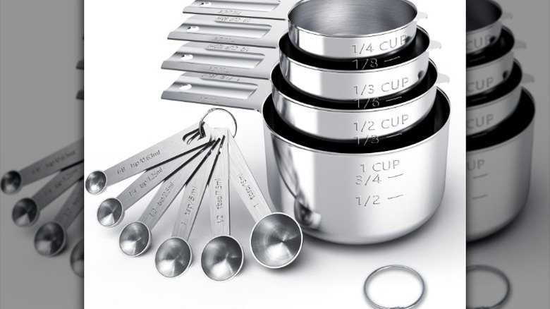 Measuring spoons and cups set on white background